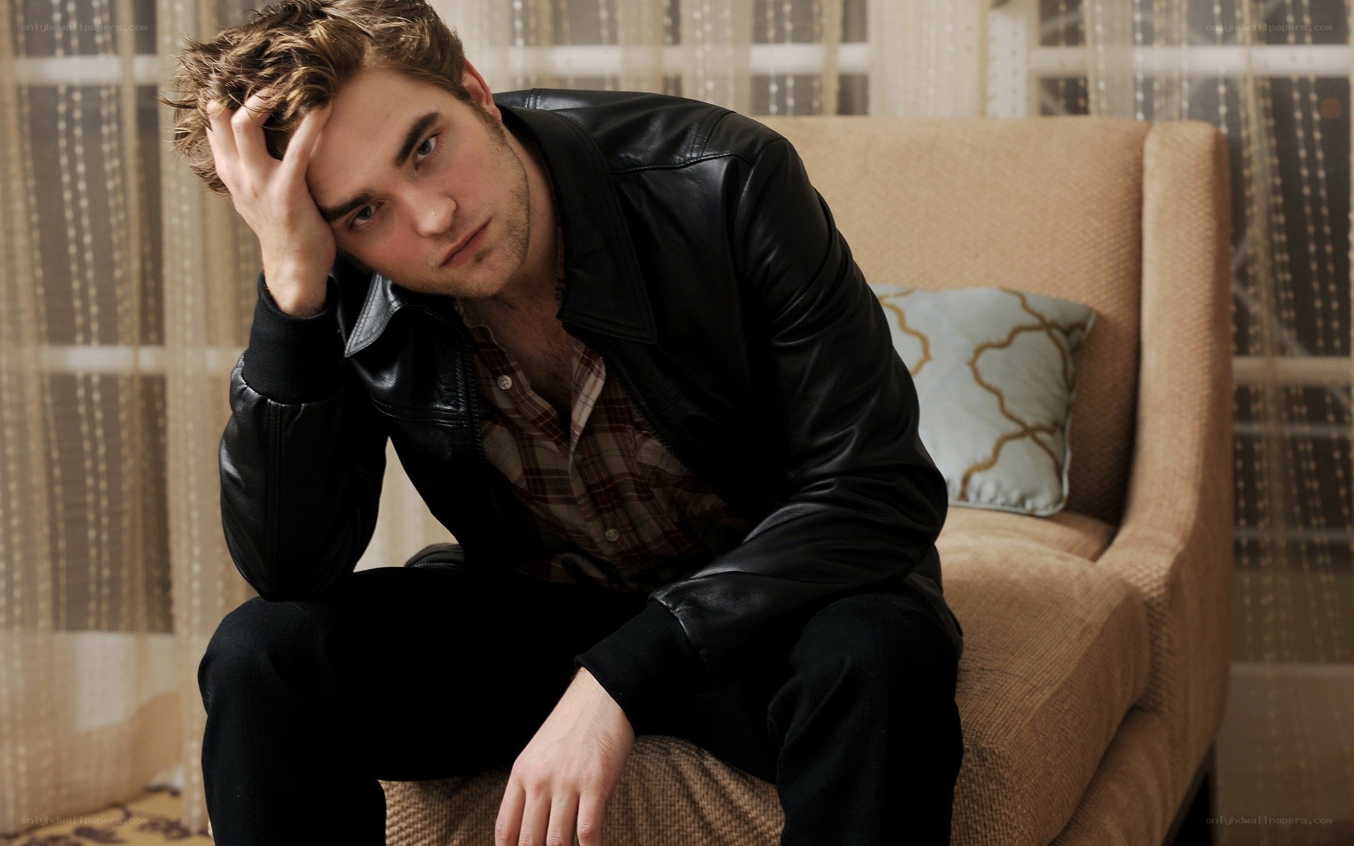 man in leather jacket sitting
