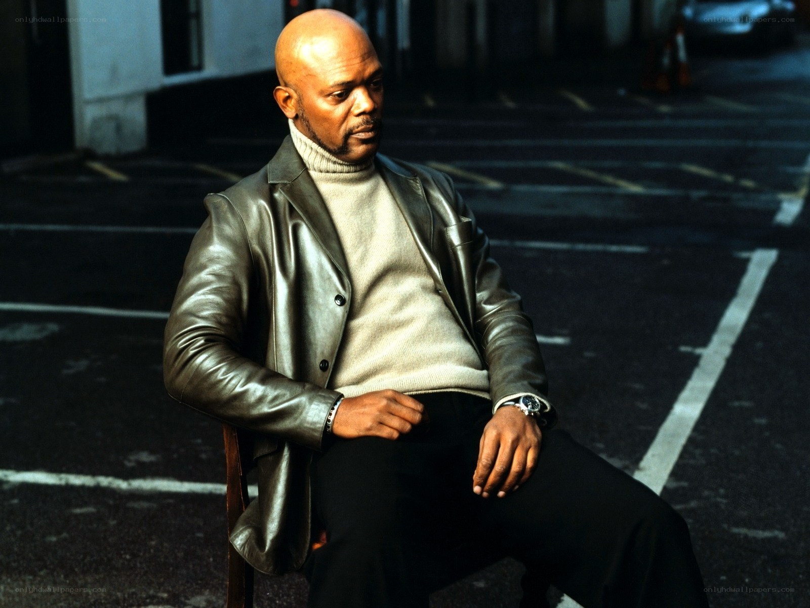 man in leather jacket sitting