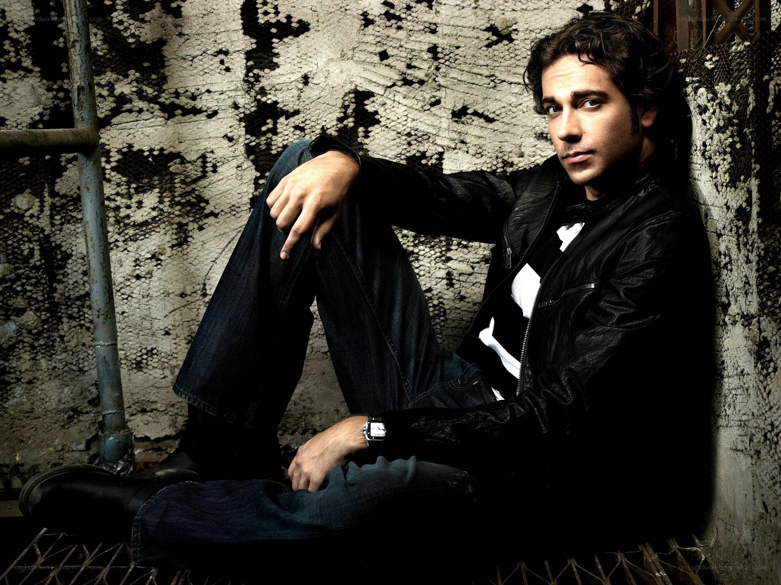 man in leather jacket sitting