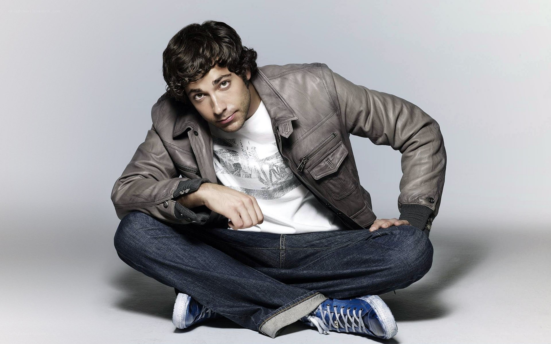 man in leather jacket sitting