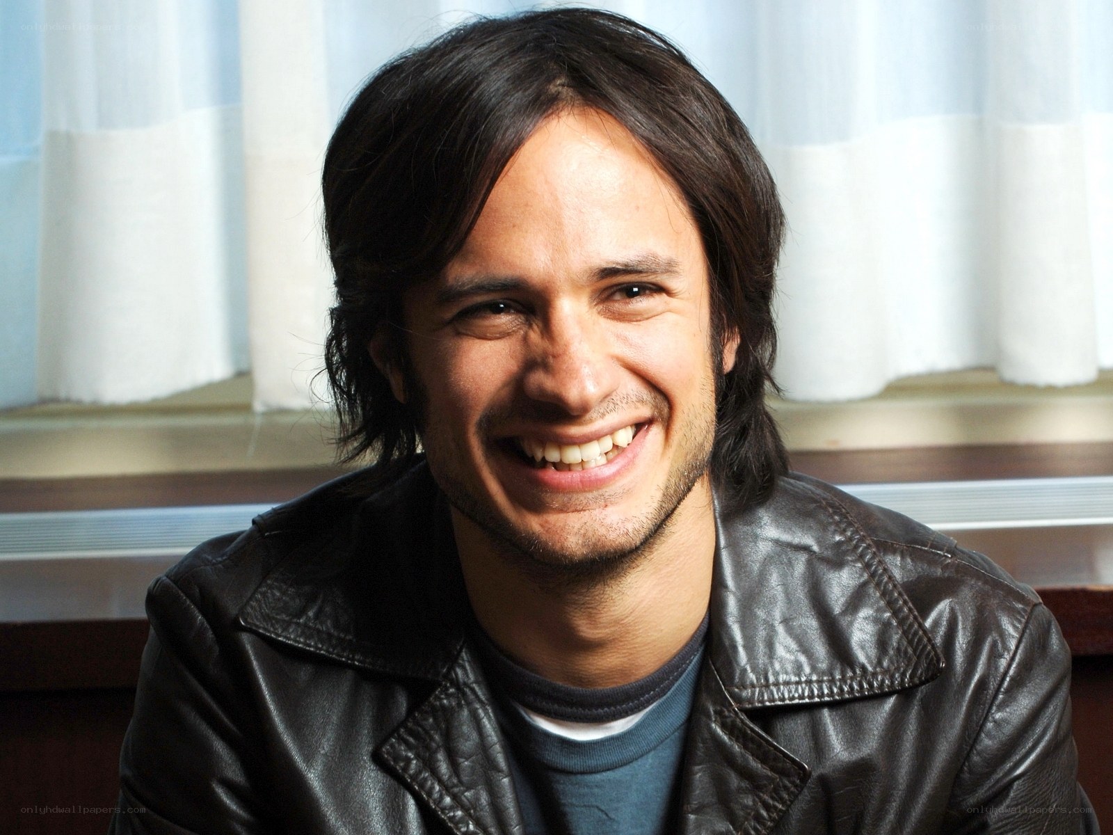 man in leather jacket smiling