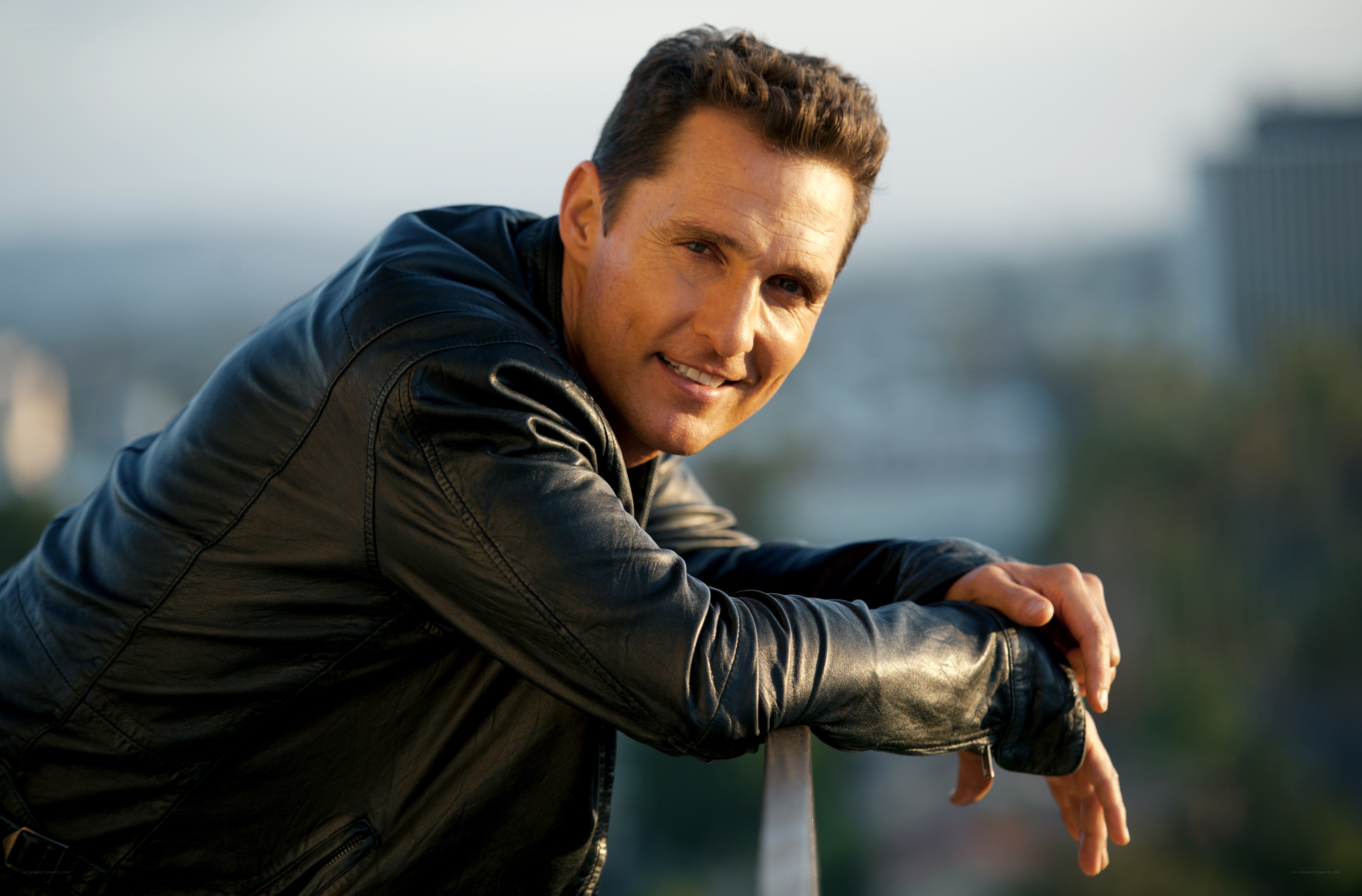 Man in leather jacket smiling