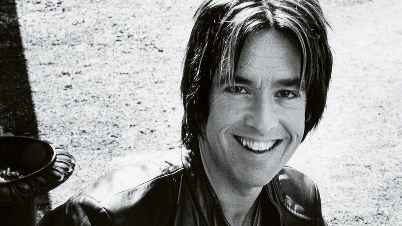 man in leather jacket smiling