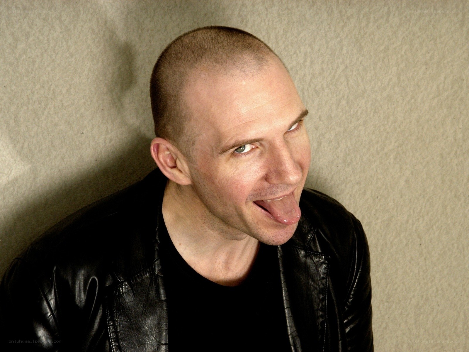 man in leather jacket sticking out tongue
