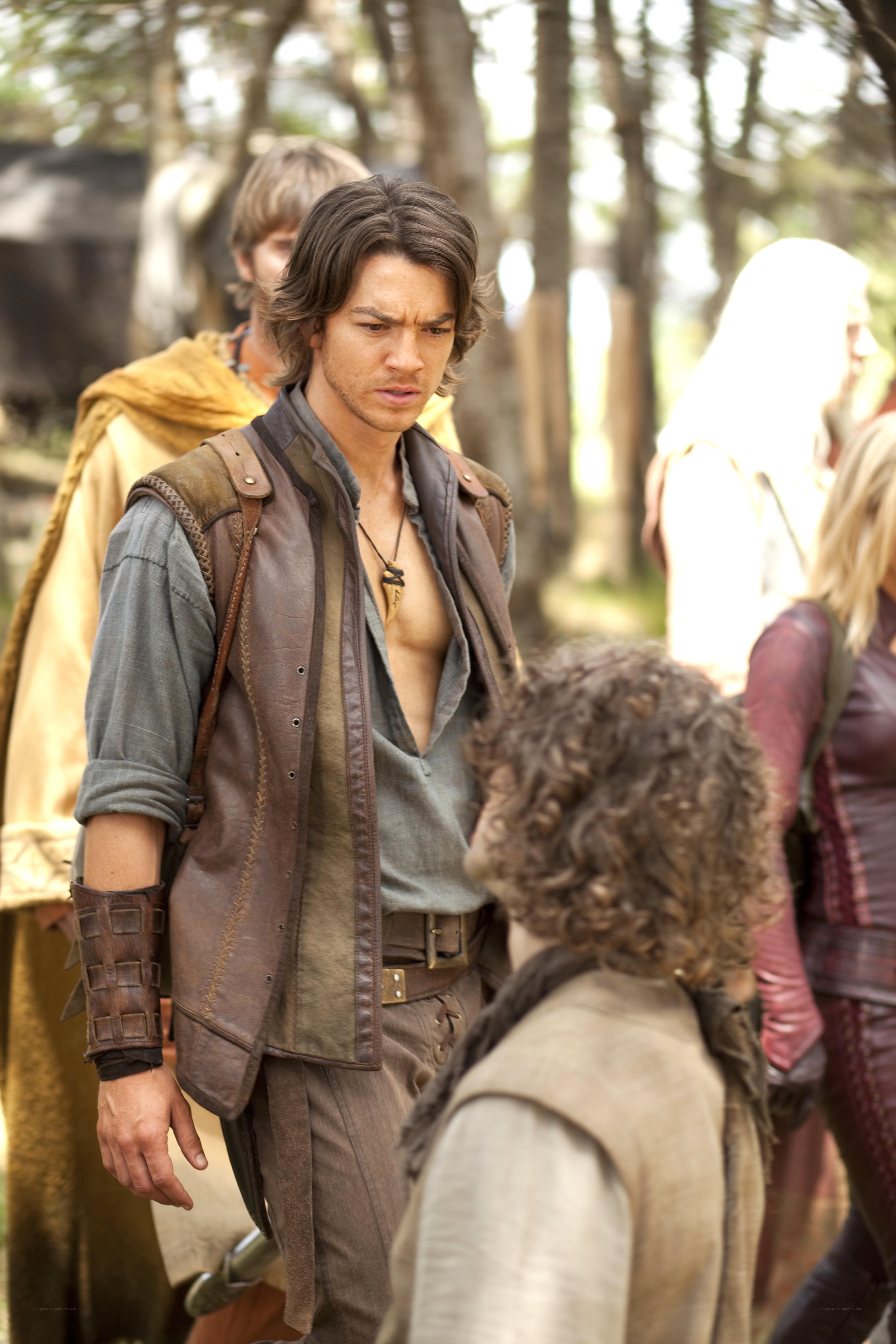 man in leather vest in forest