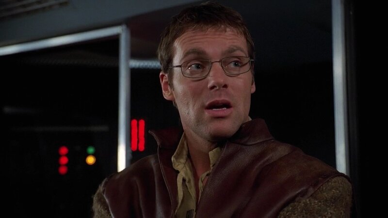 man in leather vest looking surprised