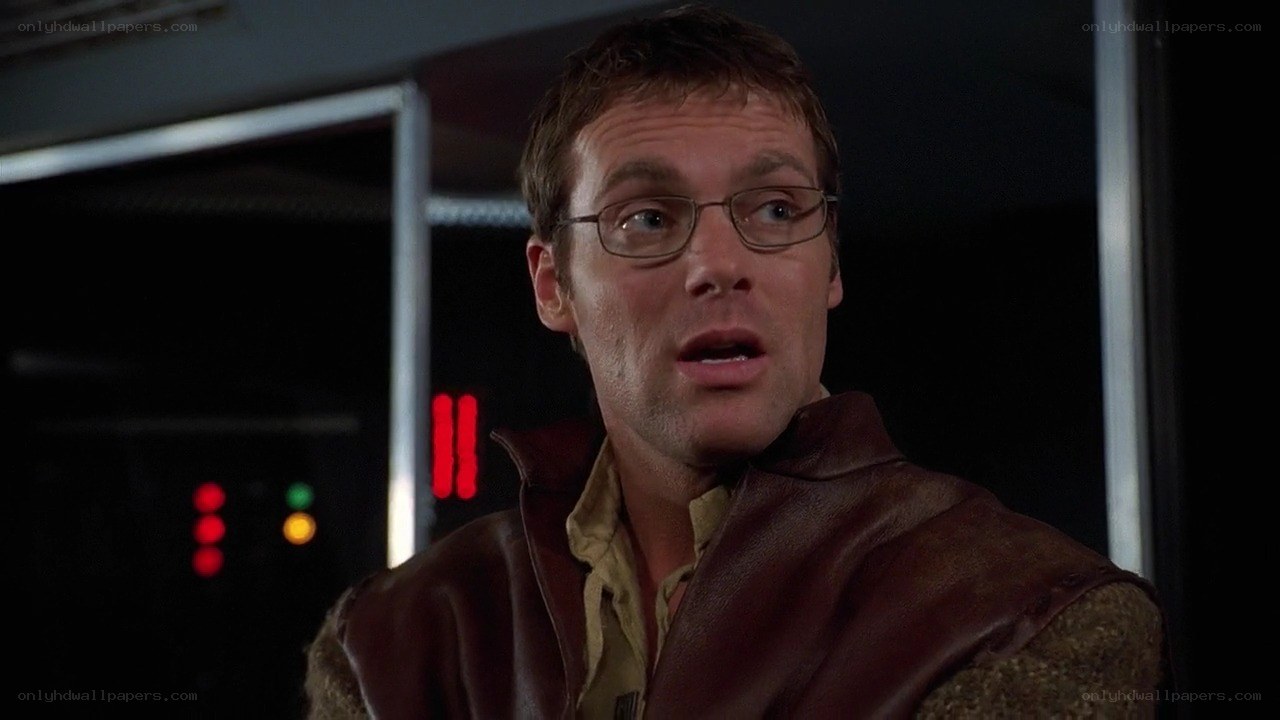 man in leather vest looking surprised