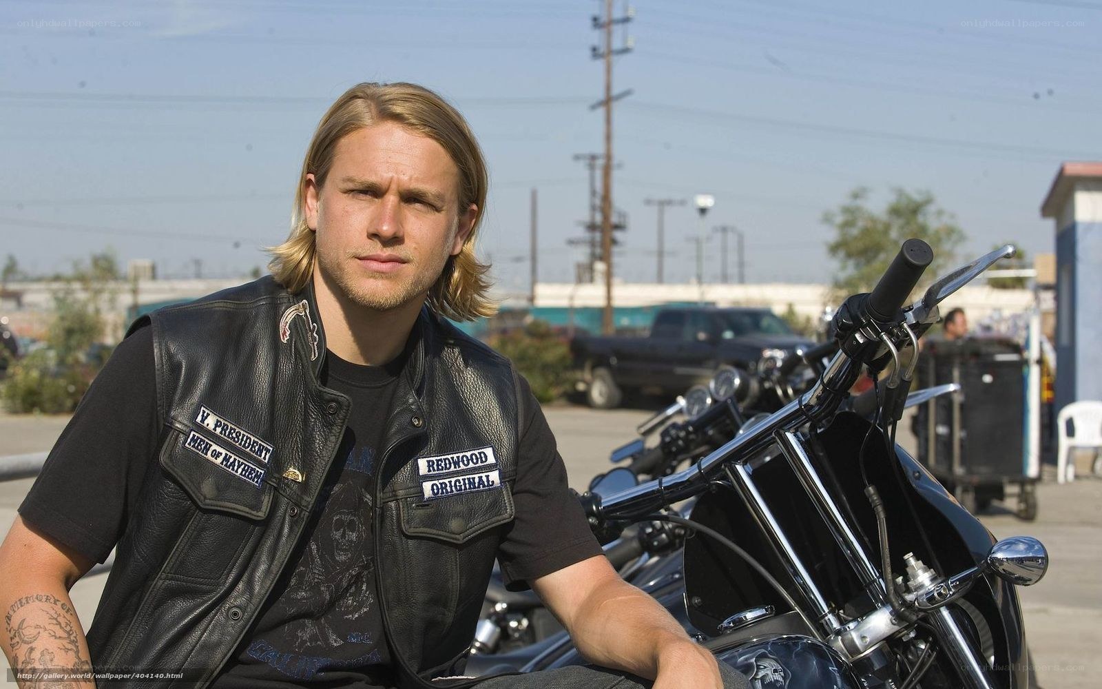 man in leather vest with motorcycle