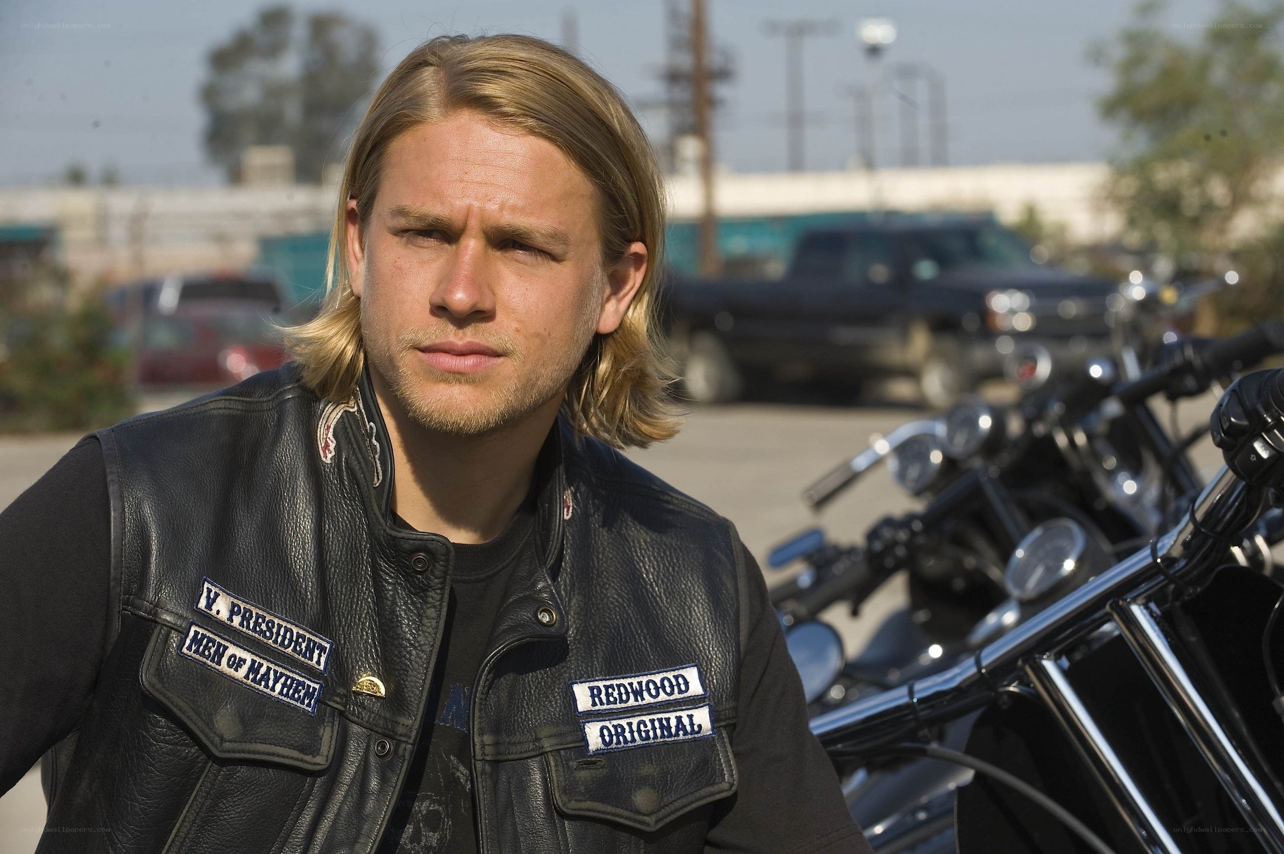 man in leather vest with motorcycle