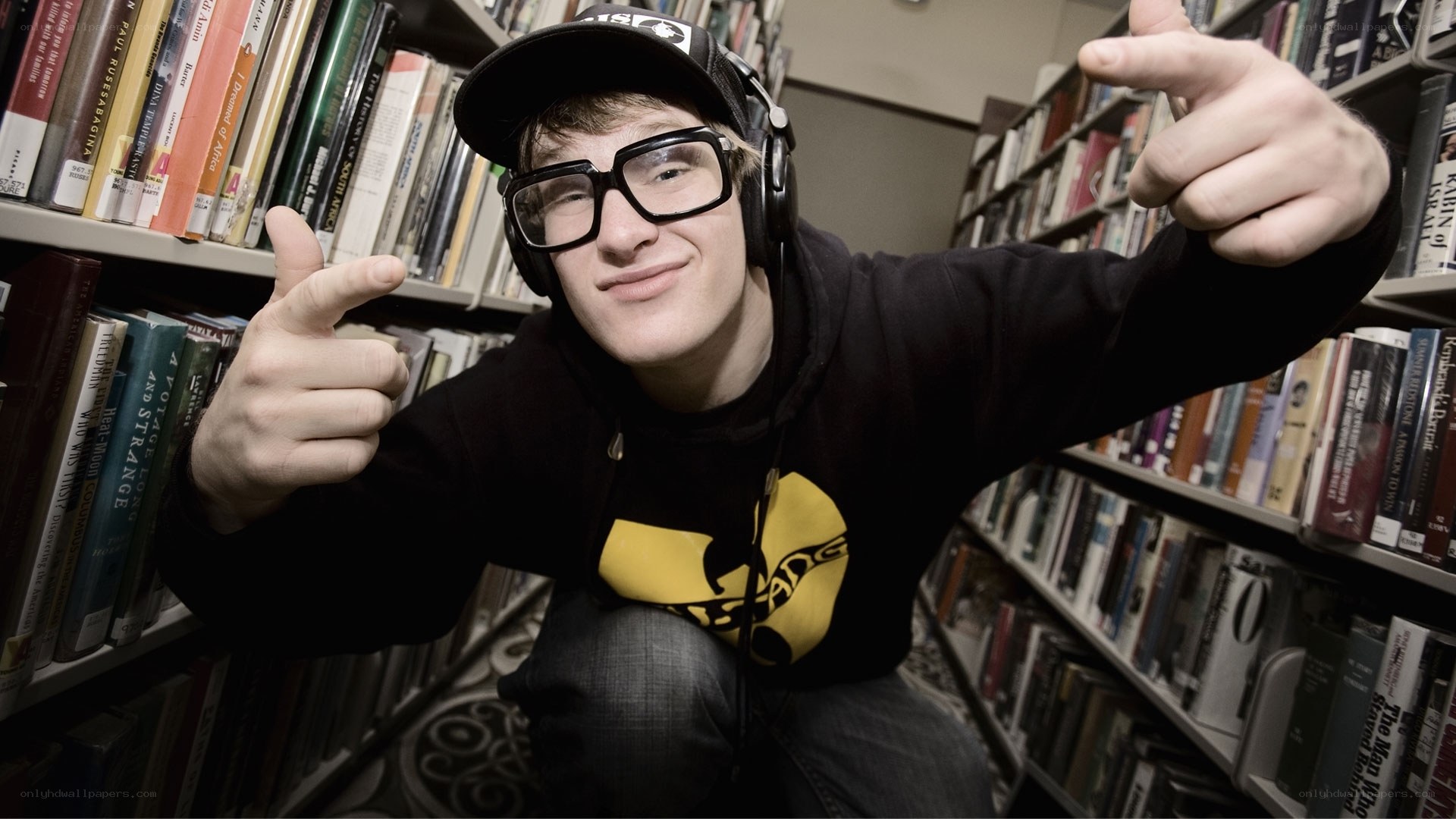 man in library with headphones