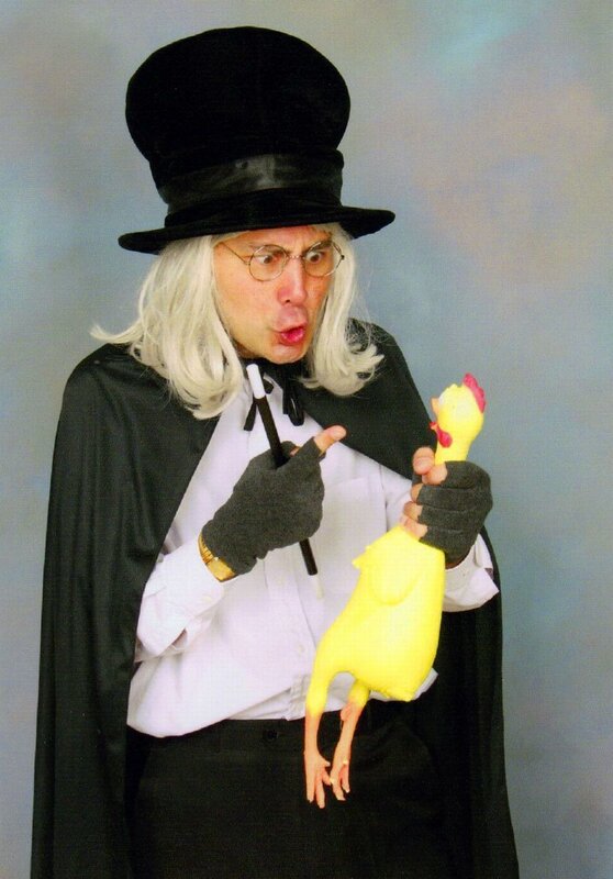 Man in magician costume with rubber chicken