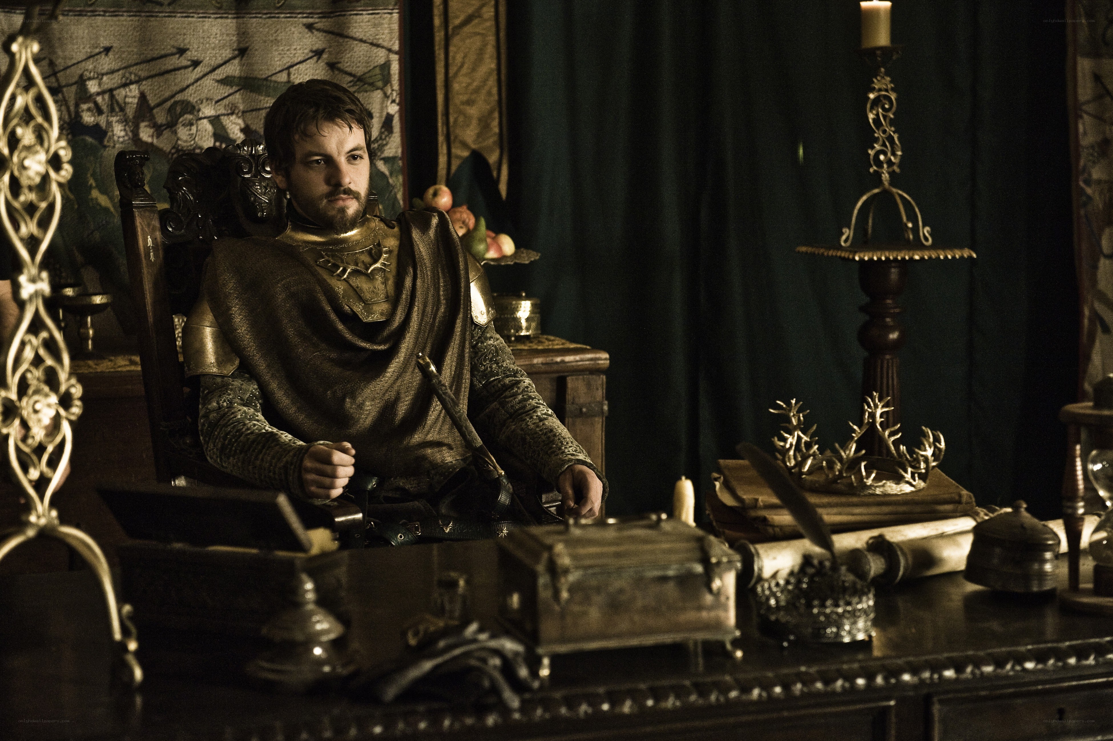 man in medieval armor at desk