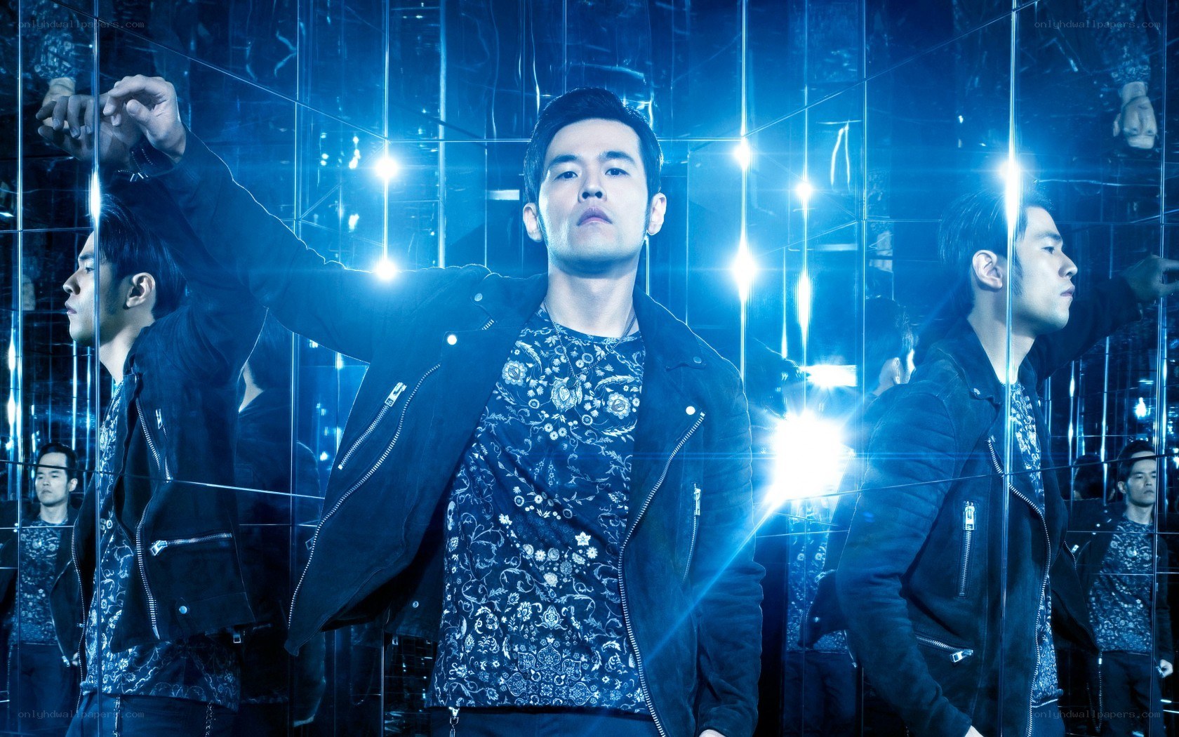 man in mirrored room with blue lights