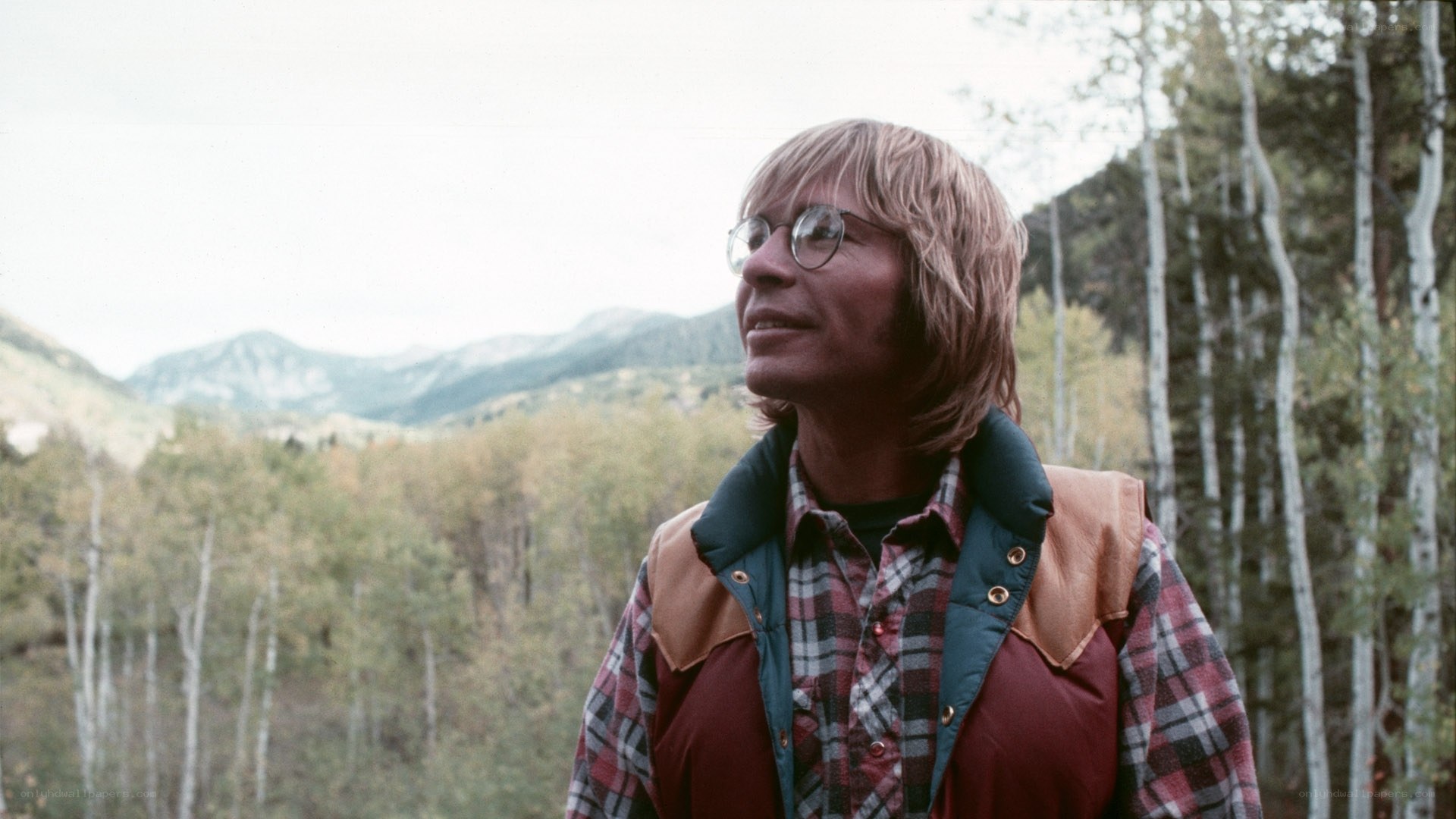 man in mountains with glasses