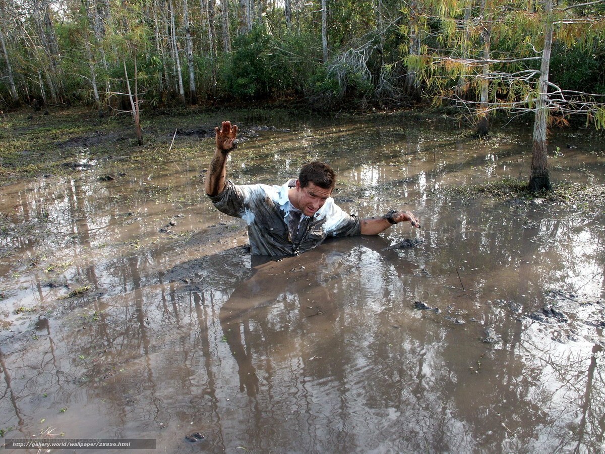 man in muddy swamp