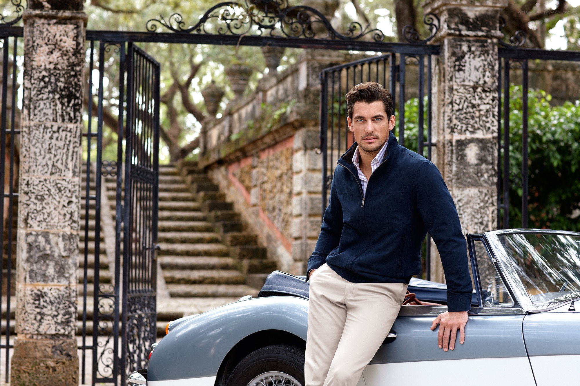 Man in navy jacket by classic car