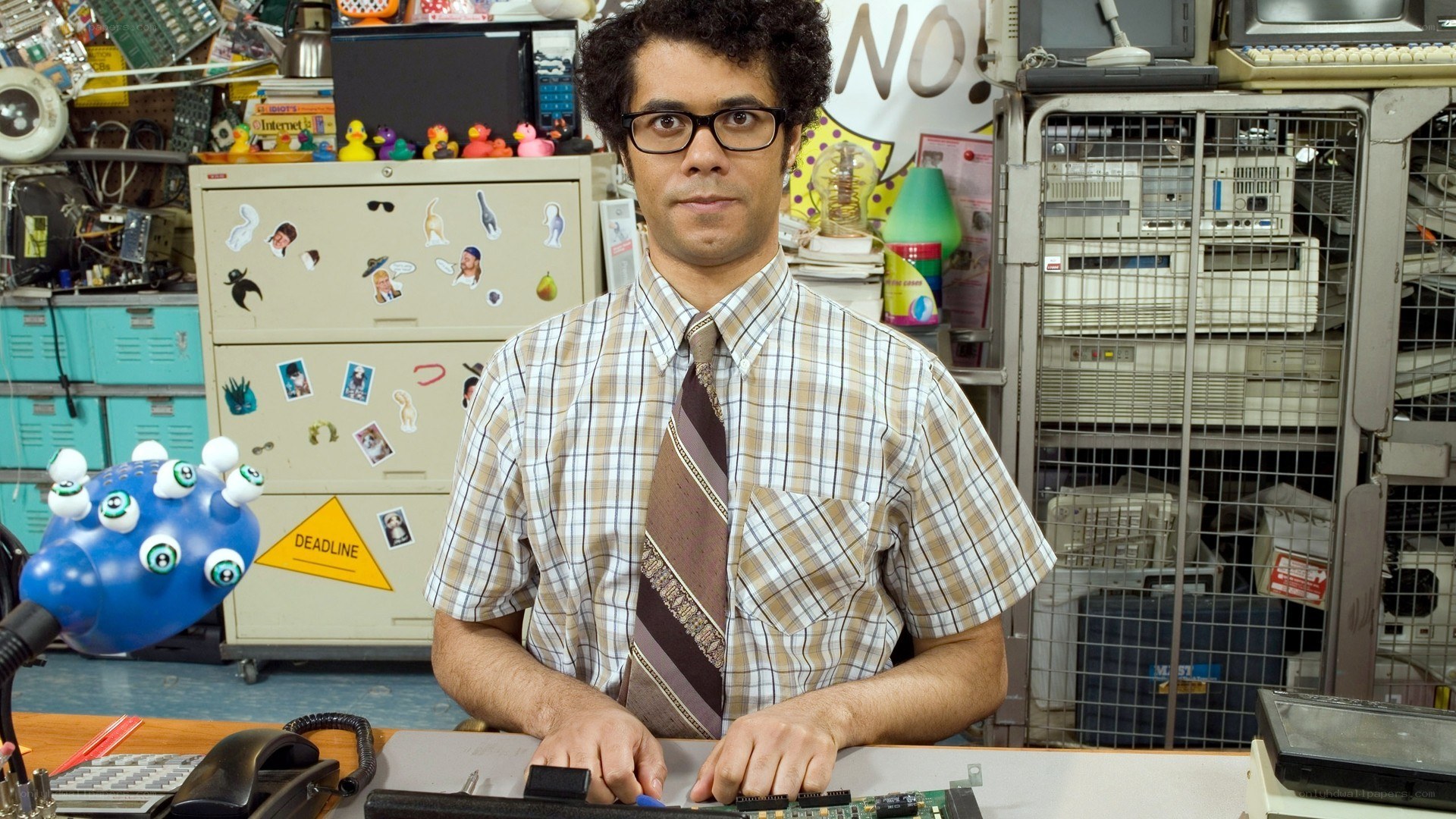 man in office with computer parts