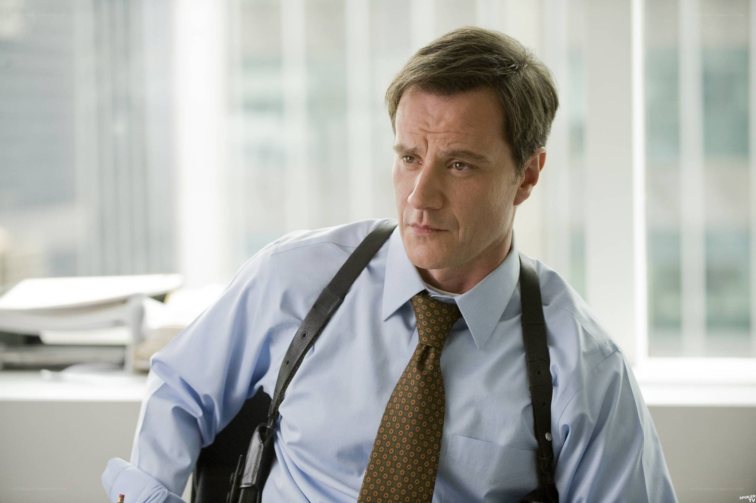man in office with gun