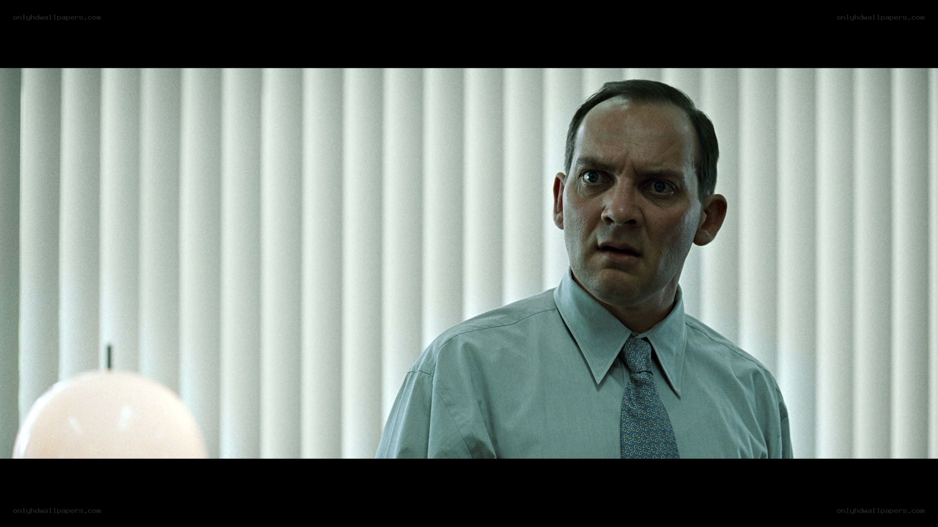man in office with shocked expression