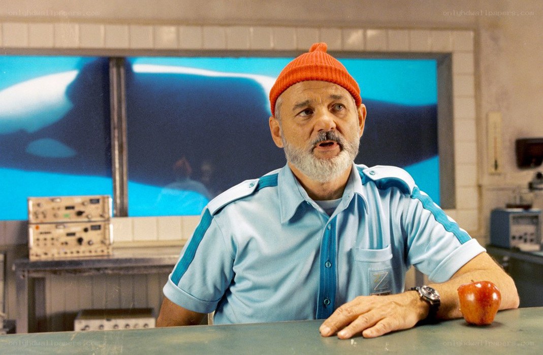 man in orange beanie at table