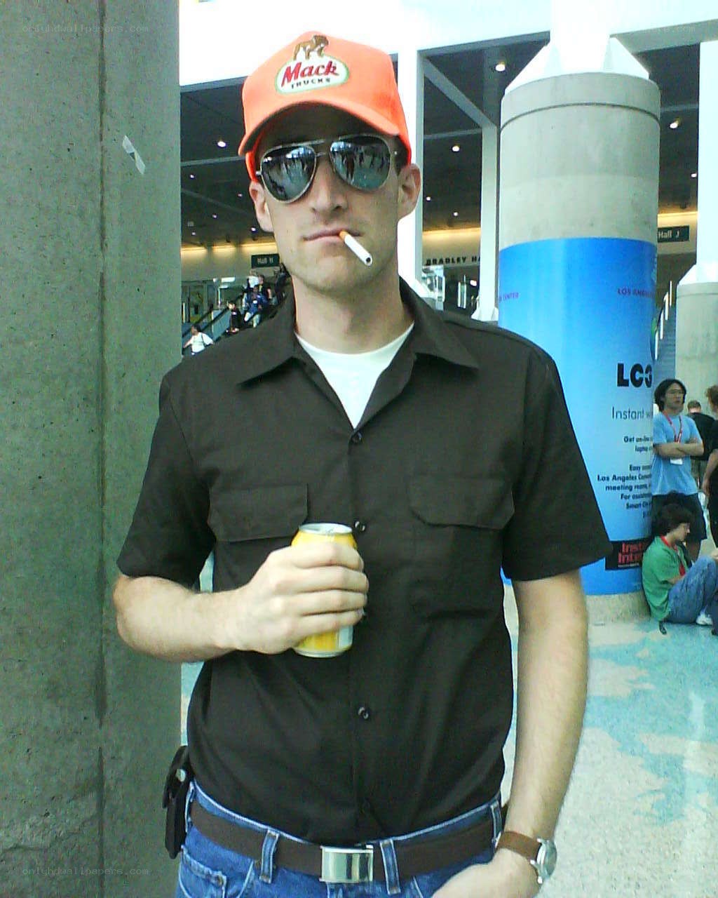man in orange cap holding can