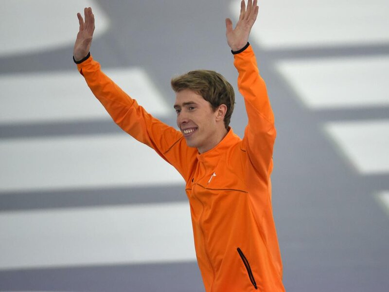 Man in Orange Jacket — Celebratory, Photograph, Ice Rink