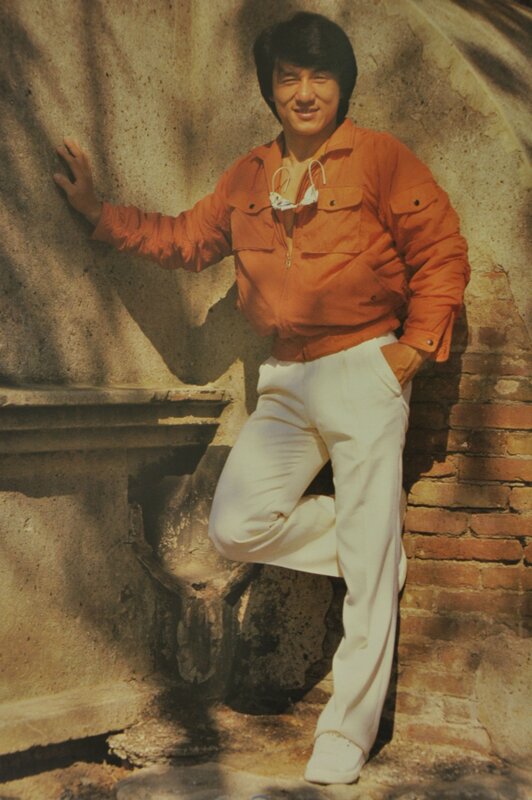 man in orange jacket posing