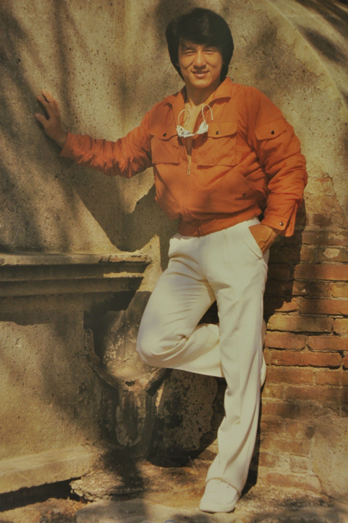 man in orange jacket posing
