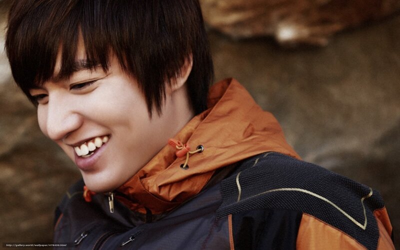 man in orange jacket smiling