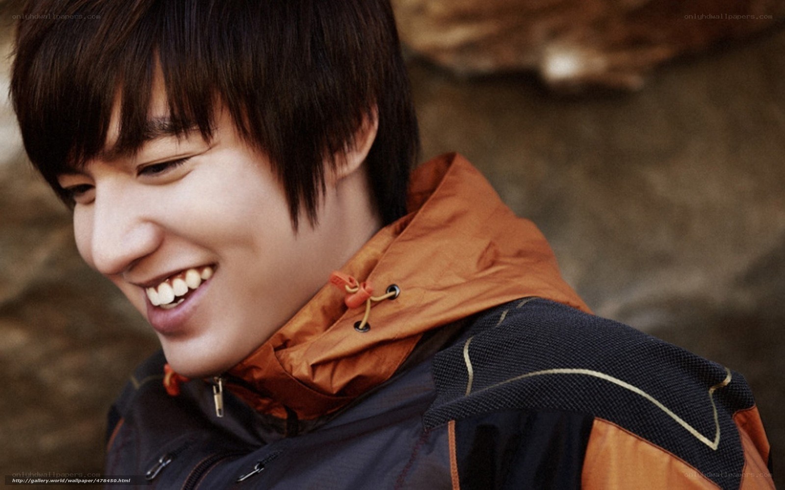 man in orange jacket smiling