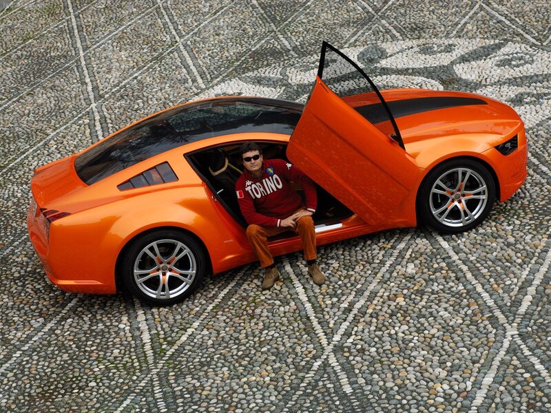 Man in orange sports car