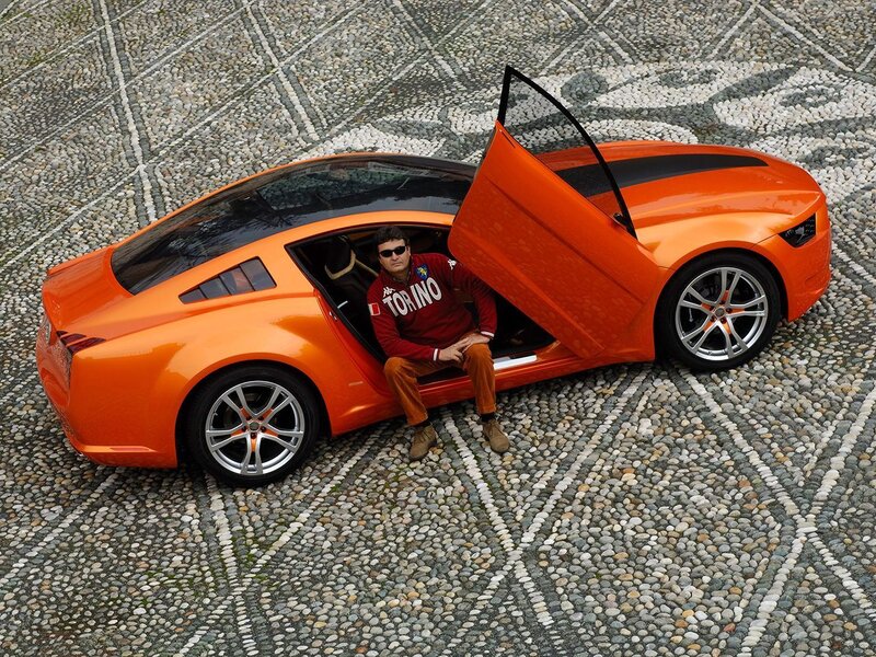 Man in orange sports car
