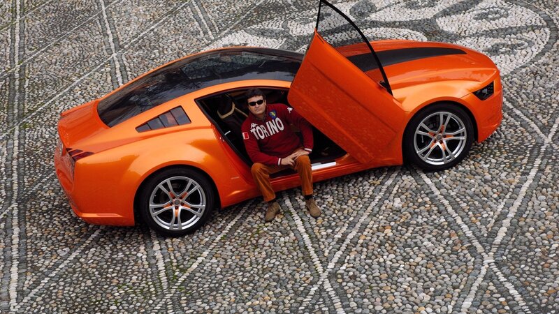 Man in orange sports car