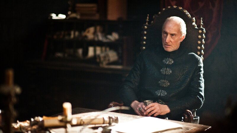 man in ornate chair at desk