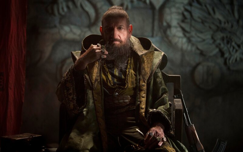 man in ornate coat holding pipe