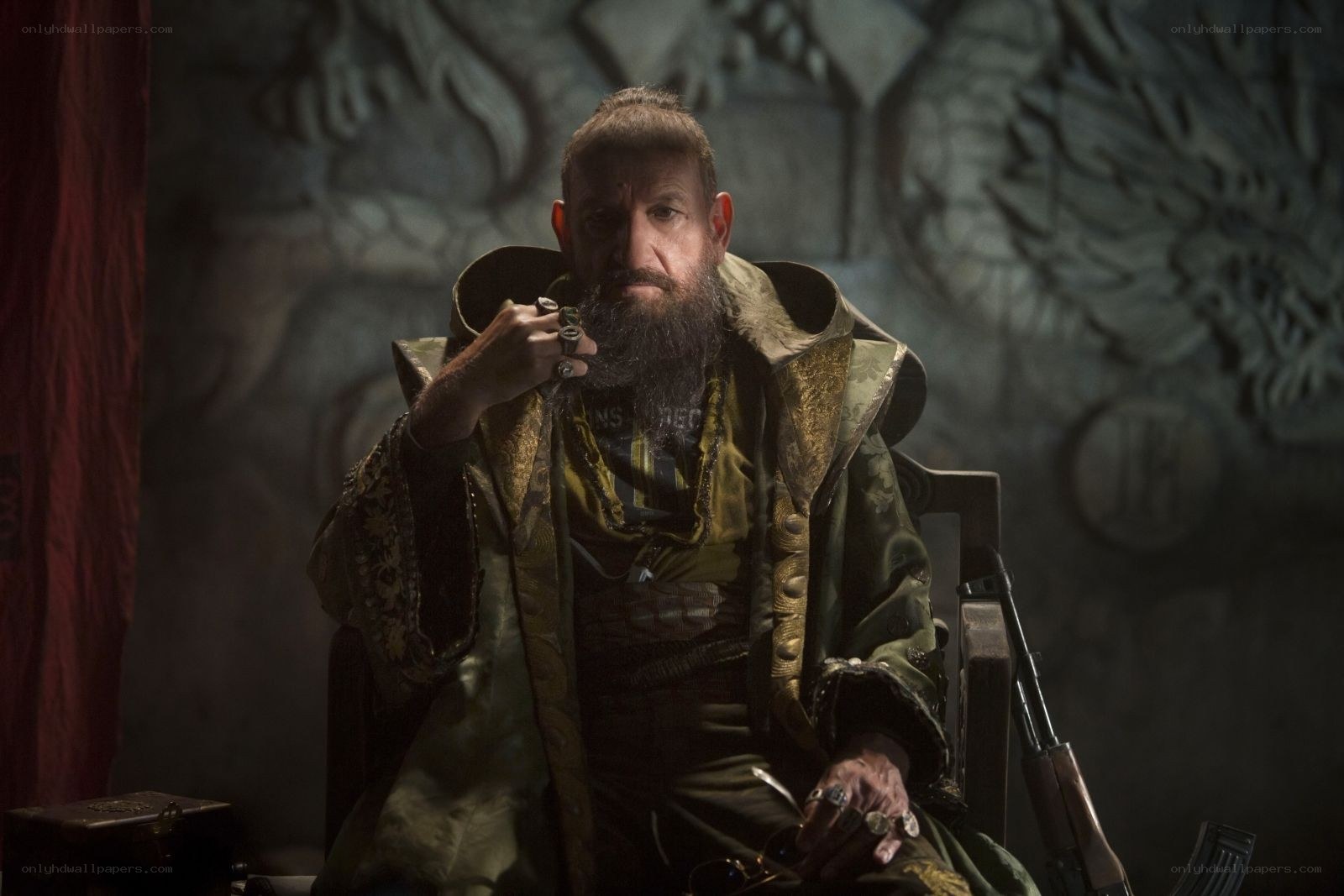 man in ornate coat holding pipe