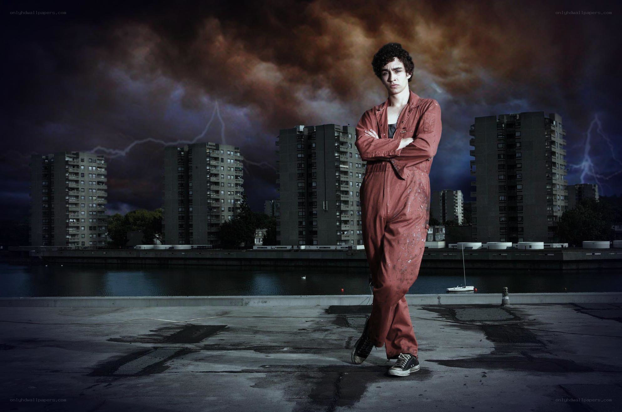 Man in overalls on rooftop