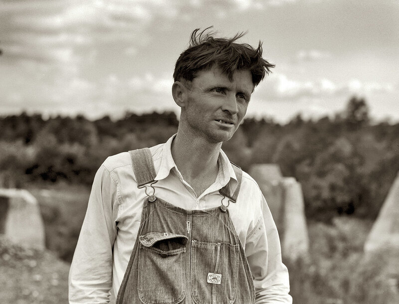 man in overalls outdoors