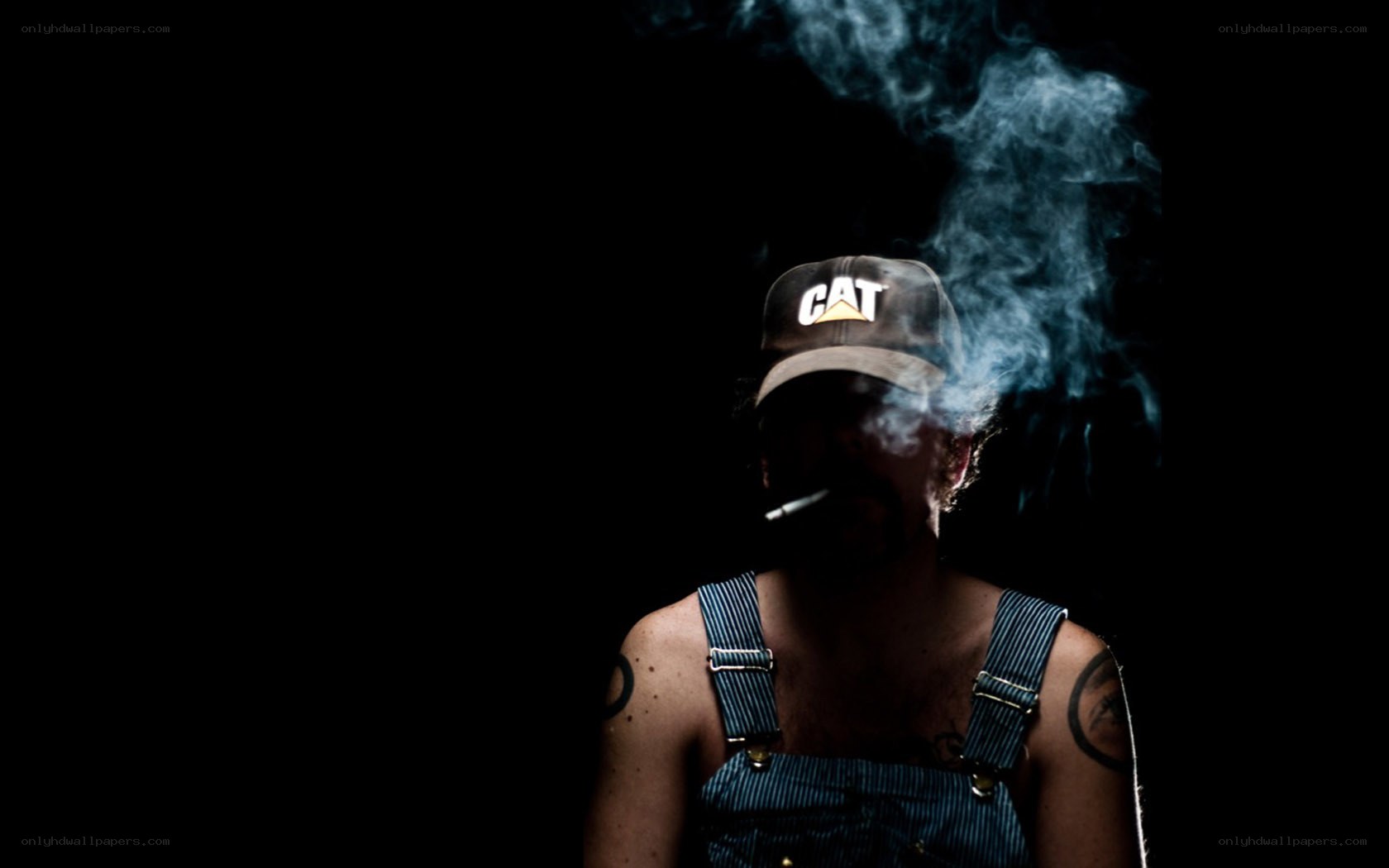 man in overalls smoking