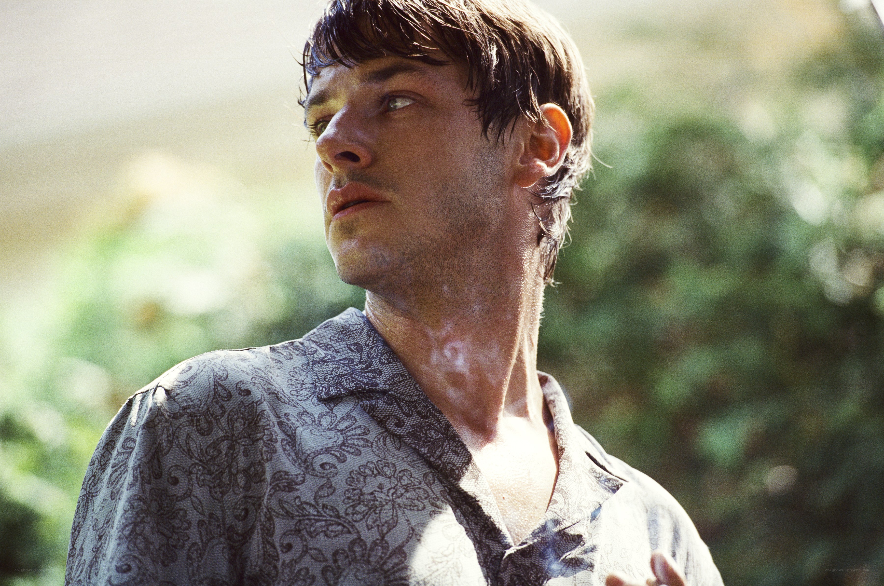 man in patterned shirt outdoors