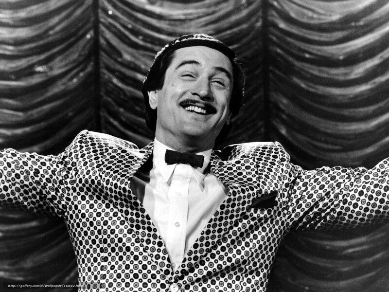 Man in patterned suit laughing