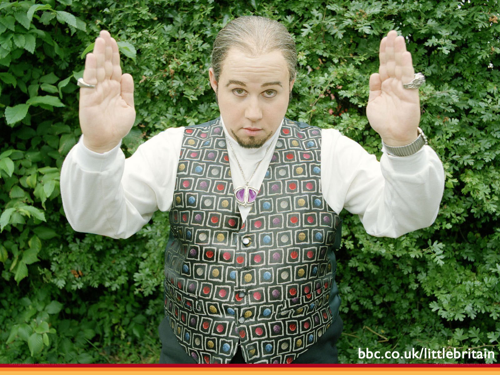 man in patterned vest outdoors