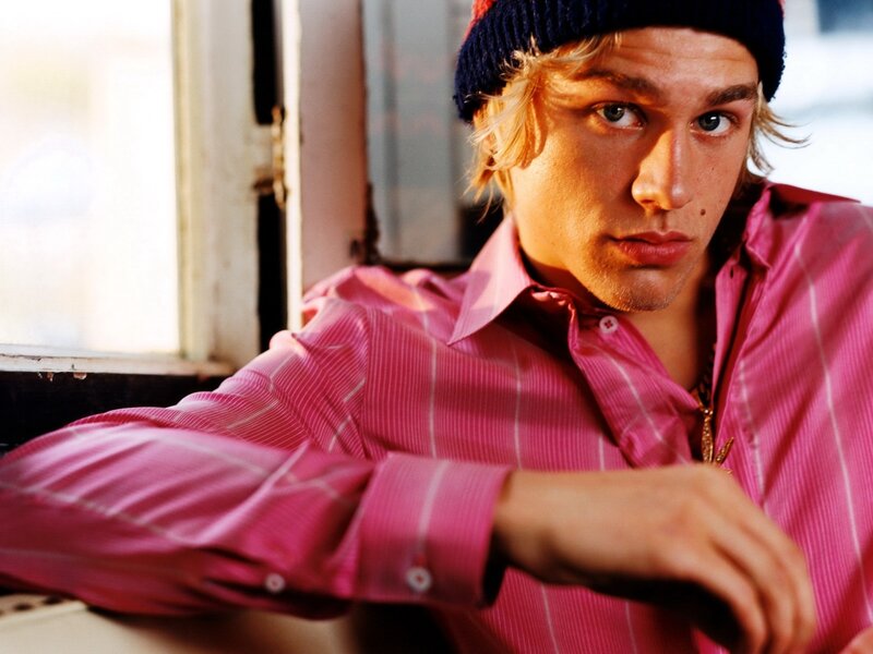 man in pink shirt and beanie