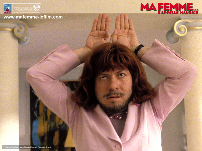 man in pink suit with hands up
