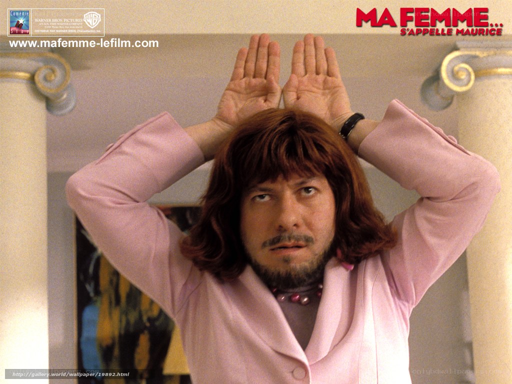 man in pink suit with hands up