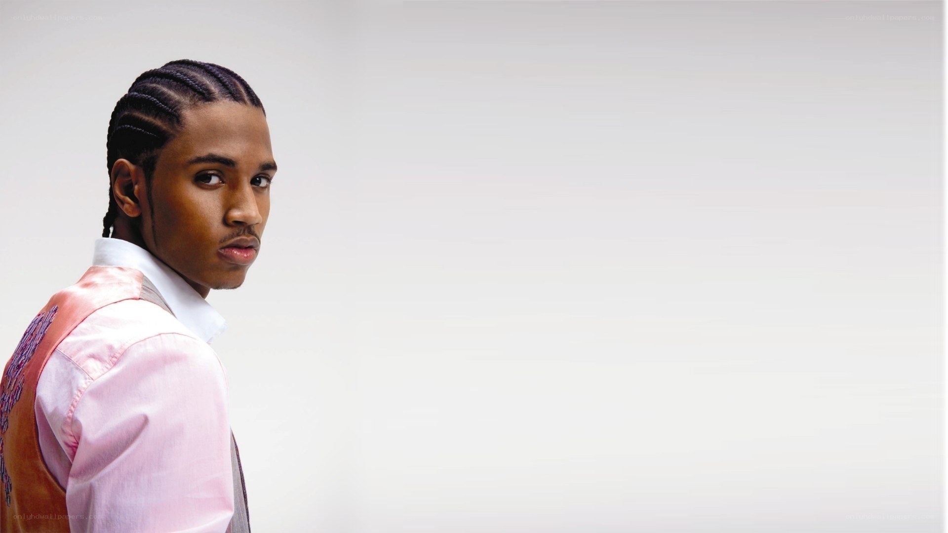 man in pink vest looking back