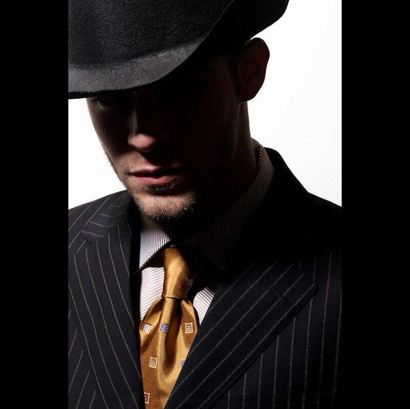 Man in Pinstripe Suit — Black, Dramatic, Photograph