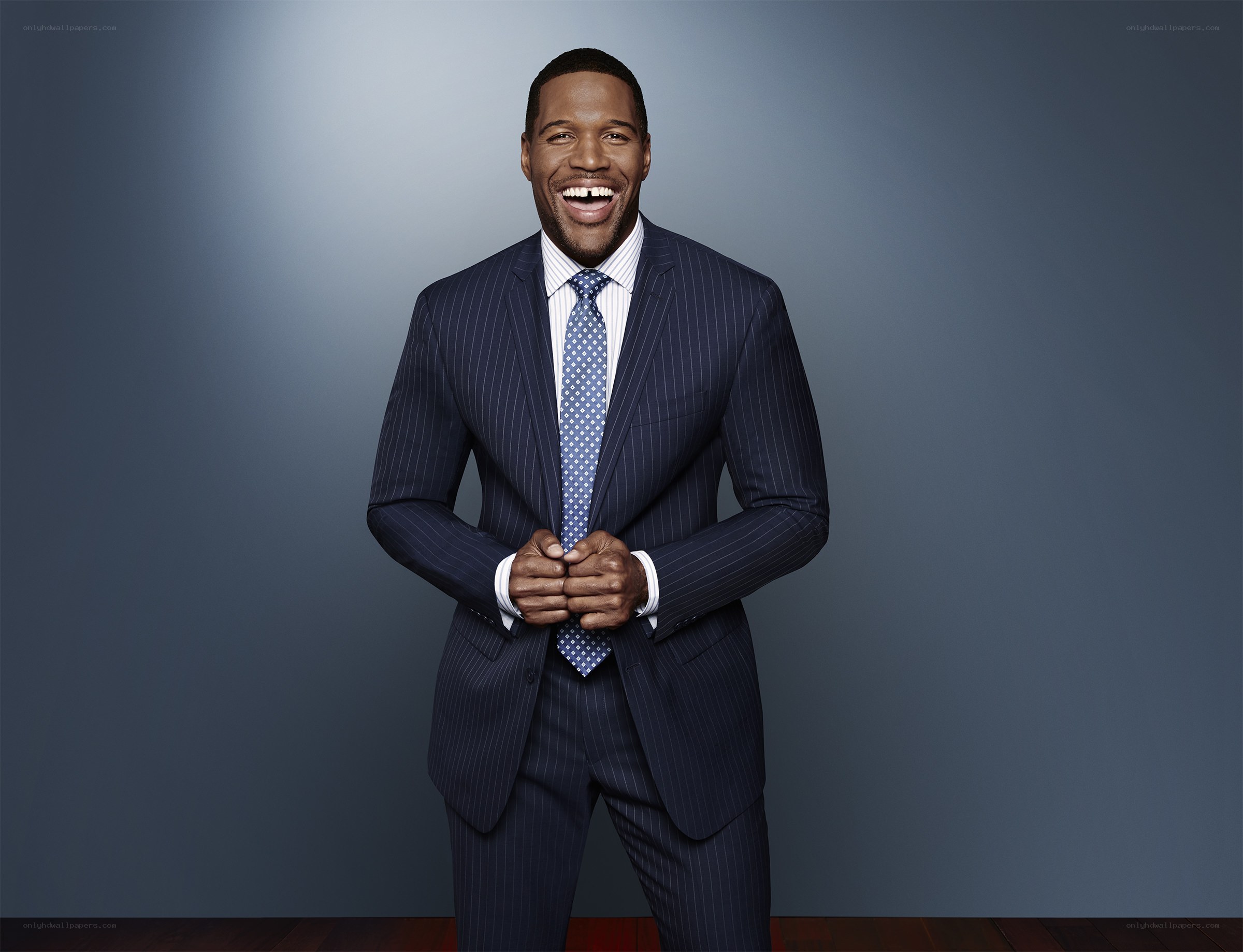 man in pinstripe suit laughing