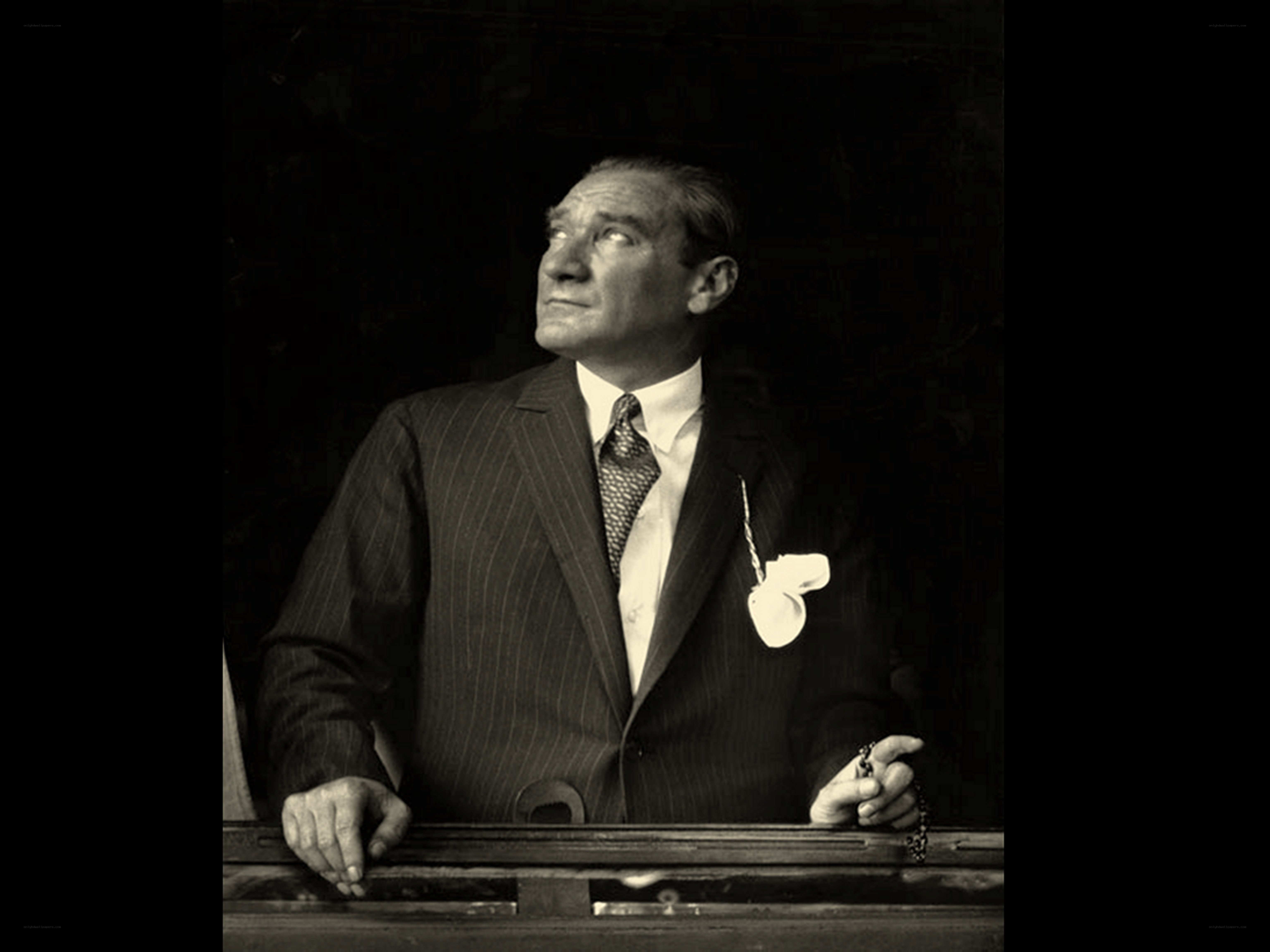 Man in pinstripe suit looking up