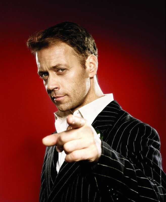 Man in pinstripe suit pointing